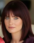 Shoulder-length dark red hair