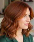 Shoulder-length auburn hair with waves and copper highlights