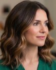 Shoulder-length brown haircut with waves and highlights