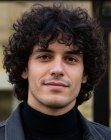 Man with collar-length curly hair