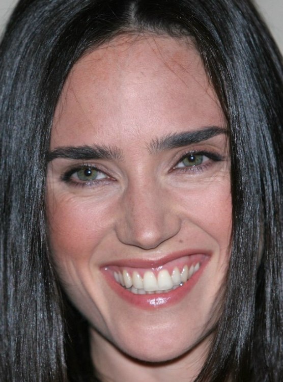 Jennifer Connelly with her long raven black hair styled to appear youthful