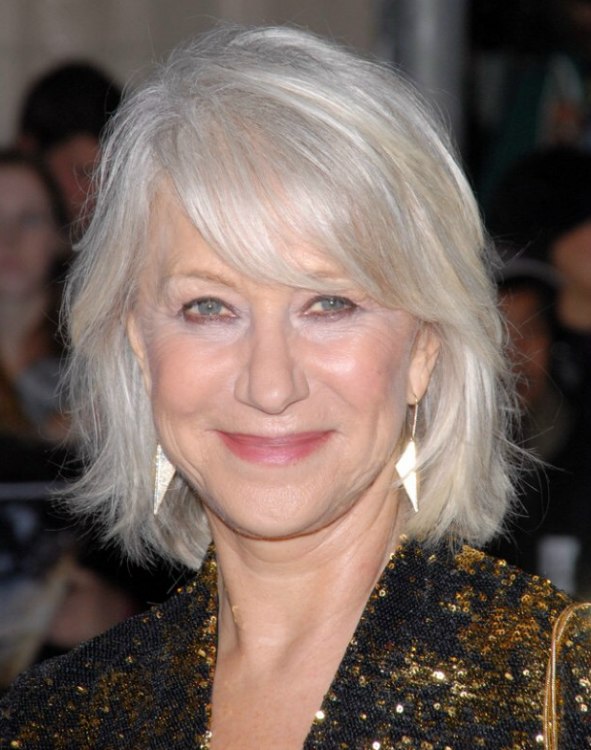 Helen Mirren with her silver white hair in a style that touches the collar