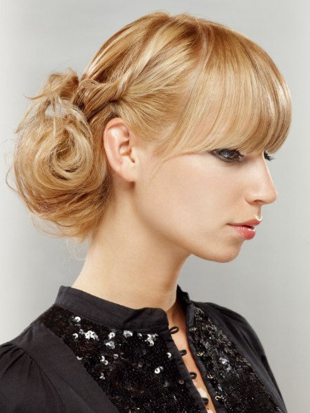 Casual upstyle with bangs and a loose chignon in the back