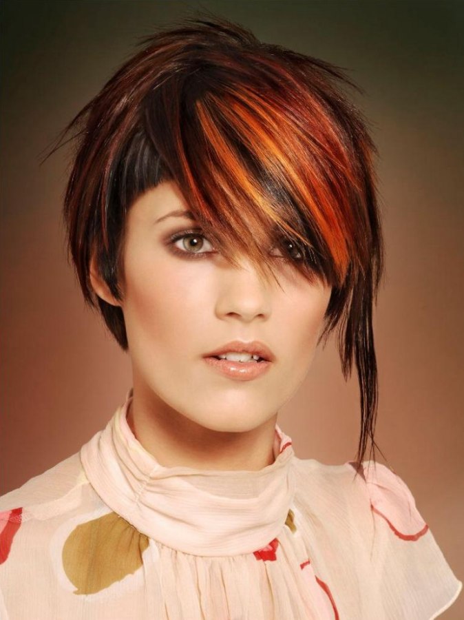 Short hairstyle with an undercut and long streaks of red hair
