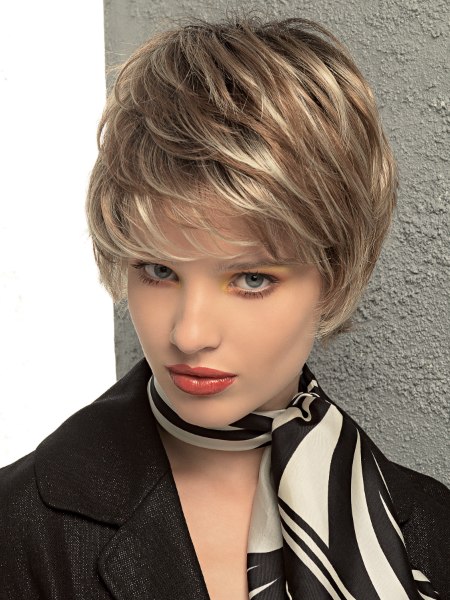 Longish pixie cut with feathered styling and lift at the scalp