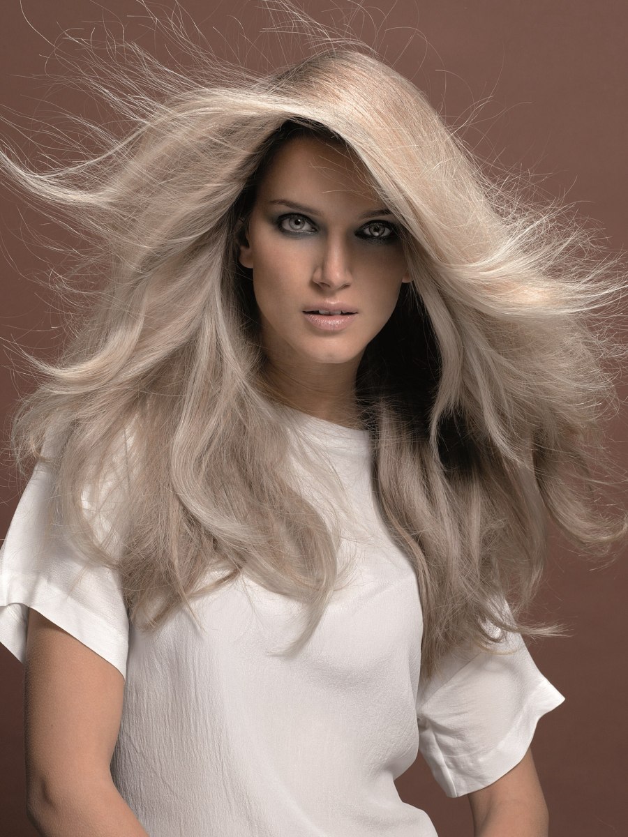 Mid back long platinum blonde hair with large layers