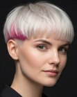 Blonde bowl cut with a pink accent
