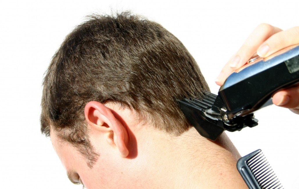 using electric clippers to cut hair